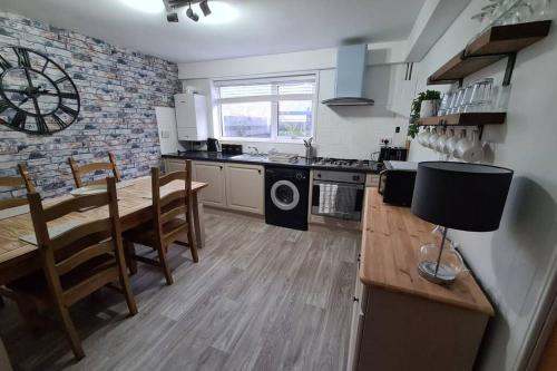 a kitchen with a table and a dining room at North Coast Property - North Coast Cottage in Thurso