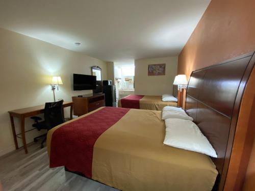 a hotel room with a bed and a desk at KINGS INN in LaFayette