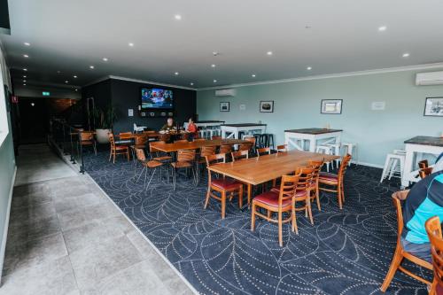 a dining room with wooden tables and chairs at Holmesville Hotel in Holmesville