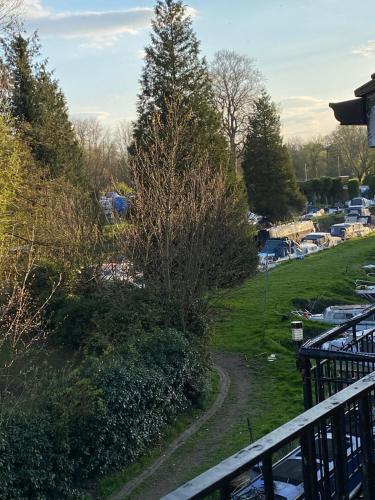 a view of a park from a balcony at Penthouse Waterfront Apartment - St Neots in Saint Neots