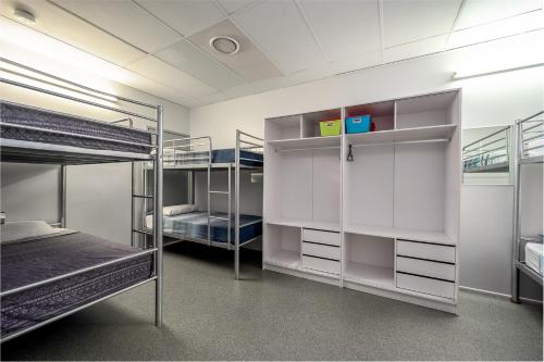 a room with three bunk beds in it at Tropical Lodge in Innisfail