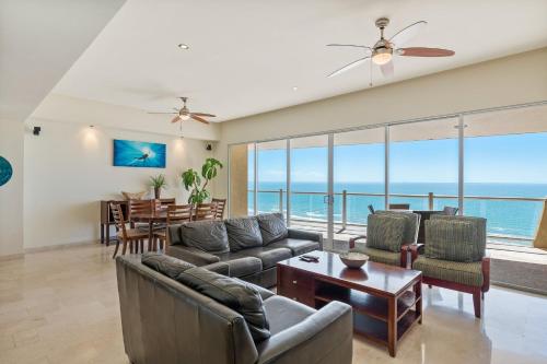a living room with a view of the ocean at Encanto Living Two Bedroom Unit by Kivoya in Puerto Peñasco