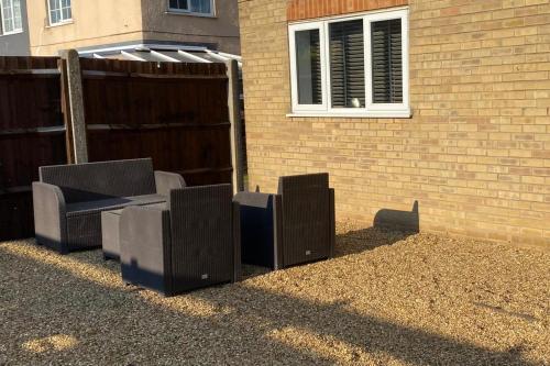a group of speakers sitting next to a building at Riverside Park Ground Floor Apartment - St Neots in Saint Neots