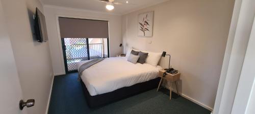 a bedroom with a bed and a window at Big River Golf & Country Club in Berri