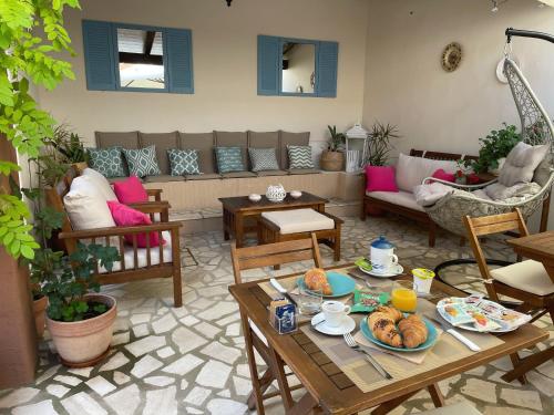 a living room with a couch and a table with food on it at B&b il Patio in Villasimius