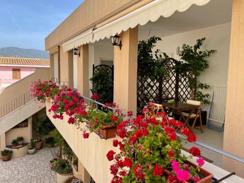 a balcony with flowers on the side of a building at B&b il Patio in Villasimius