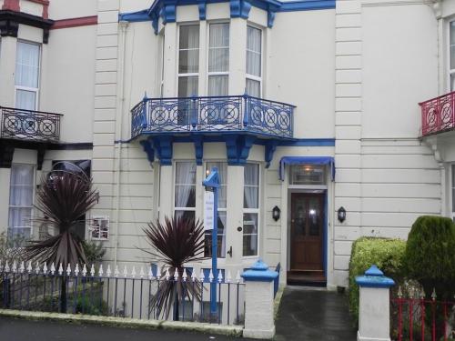 a blue and white building with a blue door at The Weston Super Mare Guest House in Weston-super-Mare