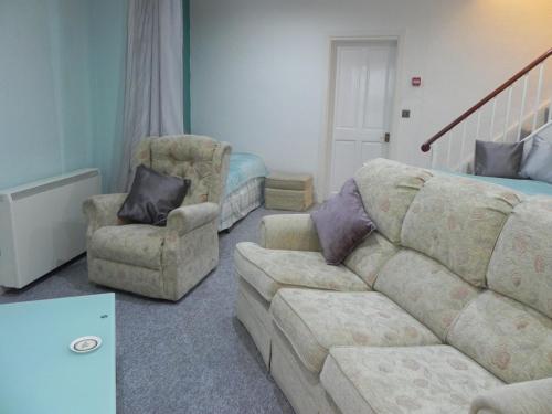 a living room filled with furniture and a couch at The Weston Super Mare Guest House in Weston-super-Mare
