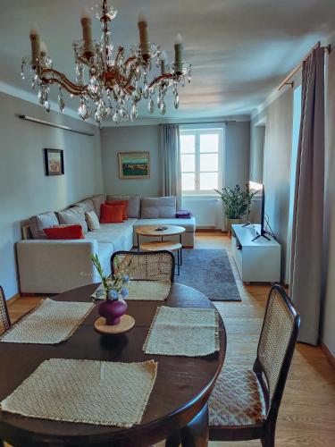 a living room with a table and a couch at Apartments Cafe Hexe in Bratislava