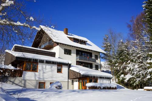 a house with snow on the roof at Schwarzwaldmädel-Ferienwohnungen in Todtnau