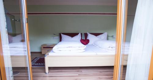 a reflection of a bedroom with a bed in a mirror at Apart Huditz in Zell am Ziller