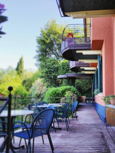 an outdoor patio with tables and chairs and a balcony at Hotel Castello S. Antonio in Lazise