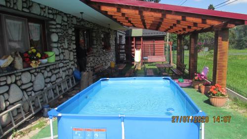a swimming pool in the yard of a house at DW U Wajdy in Białka Tatrzańska