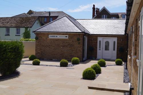a house with a brick driveway and a garage at Viking Villa in Broadstairs
