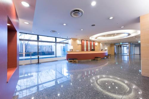 a lobby with a waiting room with a large window at Tmark City Hotel Sapporo in Sapporo