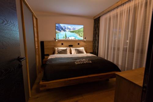 Postel nebo postele na pokoji v ubytování Moderne Wohnung mit einer wunderschönen Aussicht in der Residenz Silvretta - Inklusive Silvretta Card Premium