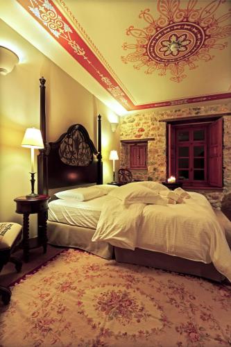 a bedroom with a large bed in a room at Archontiko Chioti in Leonidion
