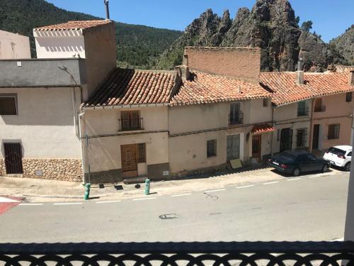 a group of buildings on the side of a street at Alojamientos Rurales Entre Rocas in Ayna