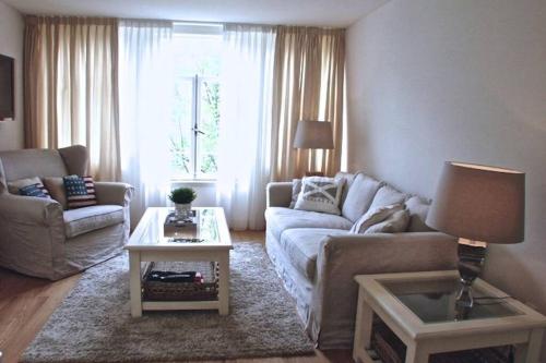 a living room with a couch and a table at Stylish Canalhouse B in Amsterdam
