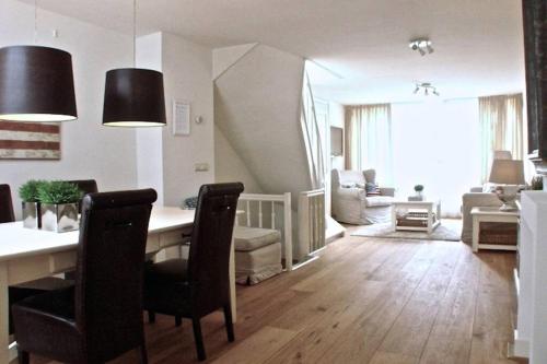 a living room with a table and chairs and a living room at Stylish Canalhouse B in Amsterdam
