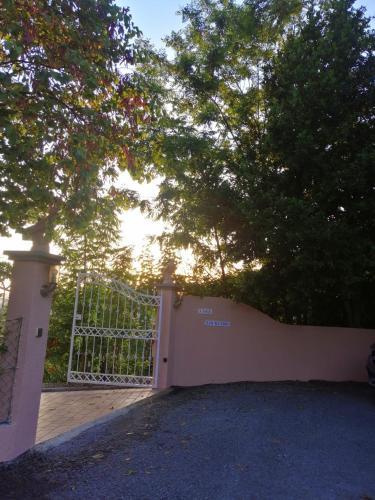 a gate with a tree in front of a house at Casa Loureiro - Vista Rio Douro in Resende