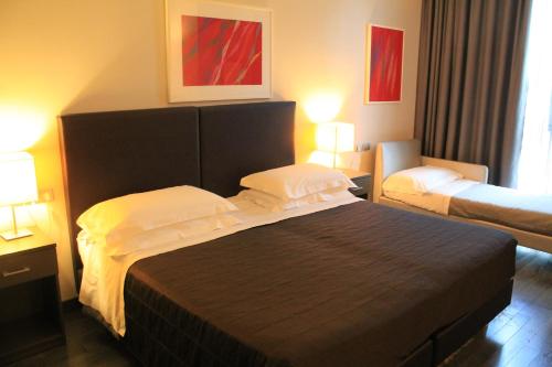 a hotel room with a bed and two beds at Park Hotel Sporting in Teramo