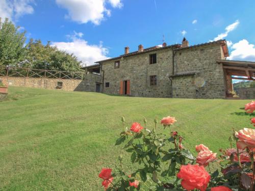 an old stone house with roses in front of it at Holiday Home Lucolena by Interhome in Lucolena in Chianti