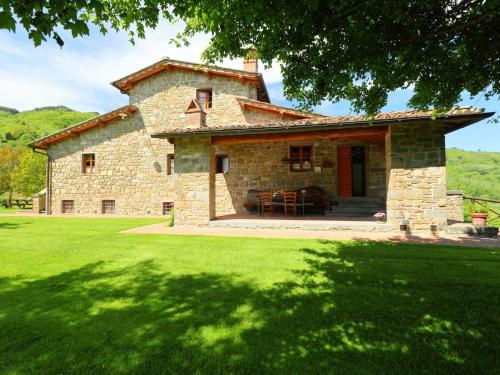 a large stone house with a large yard with green grass at Holiday Home Lucolena by Interhome in Lucolena in Chianti