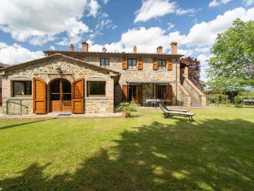 a stone house with a bench in front of it at Holiday Home Casale il Giglio-2 by Interhome in Ciggiano