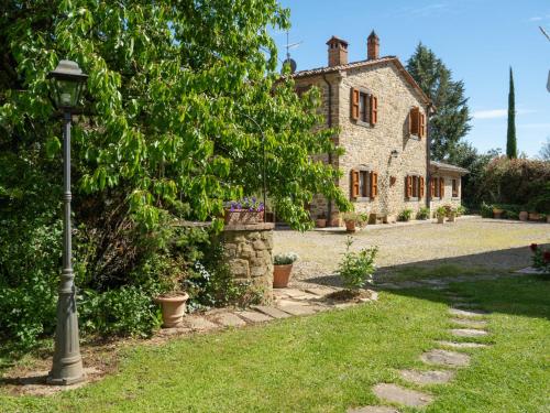 a street light in front of a stone house at Holiday Home Casale il Giglio-1 by Interhome in Ciggiano