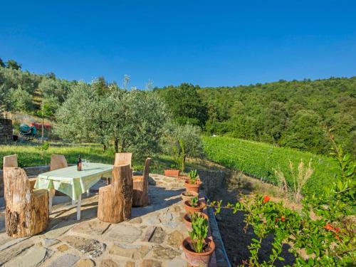 a stone patio with a table and some plants at Holiday Home Posticcia Vecchia by Interhome in Podere Monte Lucci