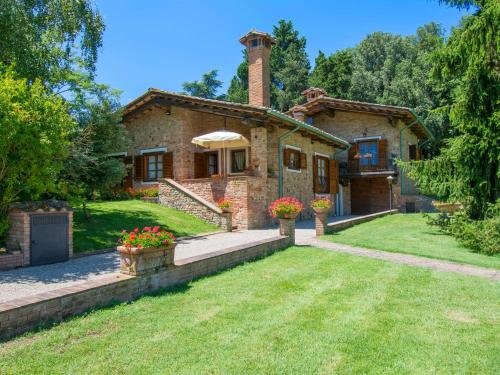 a large brick house with a grass yard at Villa Camporbiano by Interhome in Camporbiano