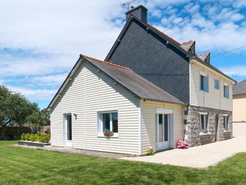 a white house with a black roof at Holiday Home Ty Manolo - TGX100 by Interhome in Tregueux