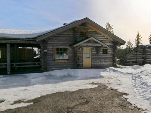 a log cabin with snow in front of it at Holiday Home Saaruantupa by Interhome in Ruka