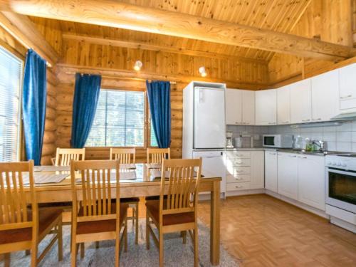 a kitchen and dining room with a table and chairs at Holiday Home Keisarintupa by Interhome in Ruka