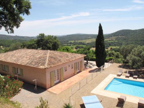 a villa with a swimming pool and a house at Holiday Home Mas des Chênes - GRI120 by Interhome in Grimaud
