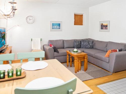 a living room with a couch and a table at Holiday Home Karhunvartijan linna a2 by Interhome in Ruka