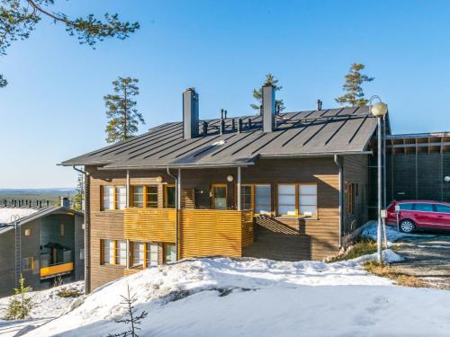 ein Haus mit einem Metalldach im Schnee in der Unterkunft Holiday Home Karhunvartijan kota b1 by Interhome in Ruka