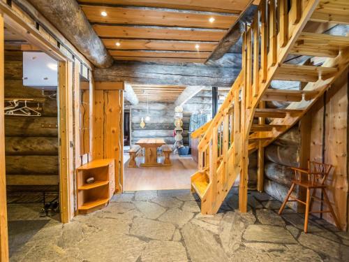 een houten trap in een kamer met houten wanden bij Holiday Home Iso-karhu by Interhome in Ruka