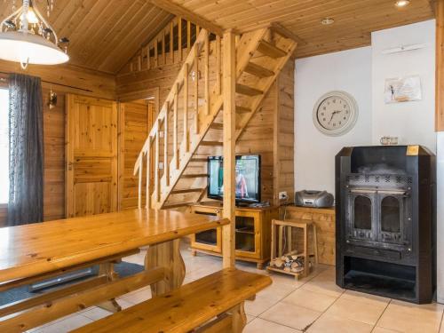 a log cabin with a wood stove and a staircase at Holiday Home Hirvas levi 1 by Interhome in Levi
