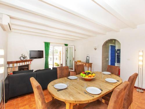 een eetkamer en een woonkamer met een houten tafel en stoelen bij Holiday Home Afrodita by Interhome in L'Escala