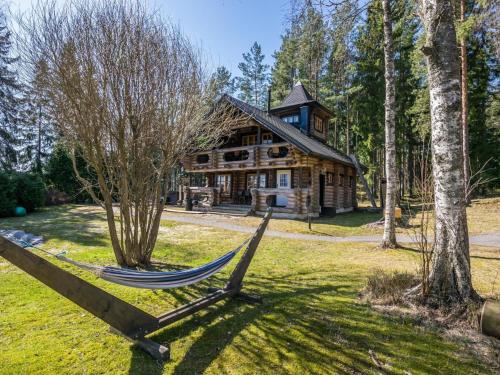 a hammock in front of a log house at Holiday Home Villa irene by Interhome in Parikka