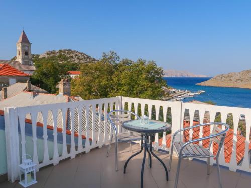 a table and chairs on a balcony with a view of the water at Holiday Home Stanka - SNJ218 by Interhome in Sveti Juraj
