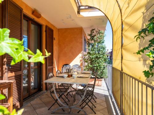 an outdoor patio with a table and chairs on a balcony at Holiday Home I Briganti by Interhome in Narzole