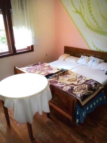 a bedroom with a bed and a table in it at Dream in Drvar