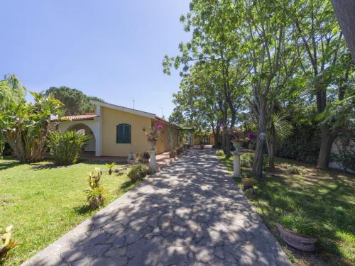 a walkway in front of a house with trees at Villa Orchidea by Interhome in Arenella