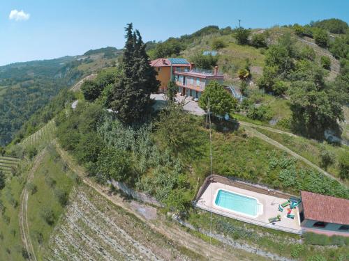 an aerial view of a house on a hill with a swimming pool at Holiday Home La Rovere by Interhome in Cossano Belbo