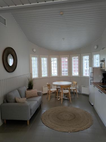 a living room with a couch and a table at Nuorisokeskus Villa Elba in Kokkola