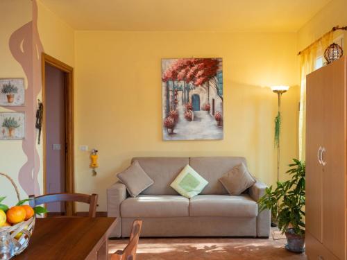 a living room with a couch and a painting on the wall at Holiday Home Casa Trinità by Interhome in Diano Borello