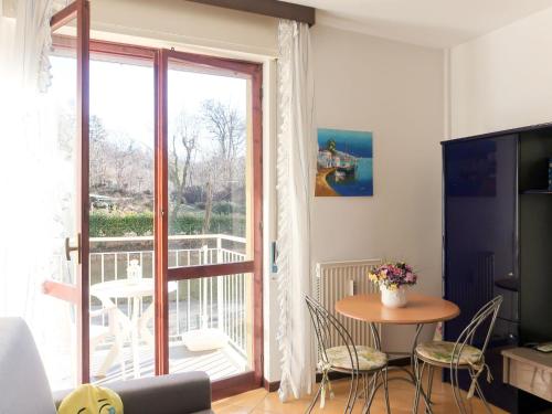 a living room with a table and a large window at Apartment Euroville-1 by Interhome in Germignaga